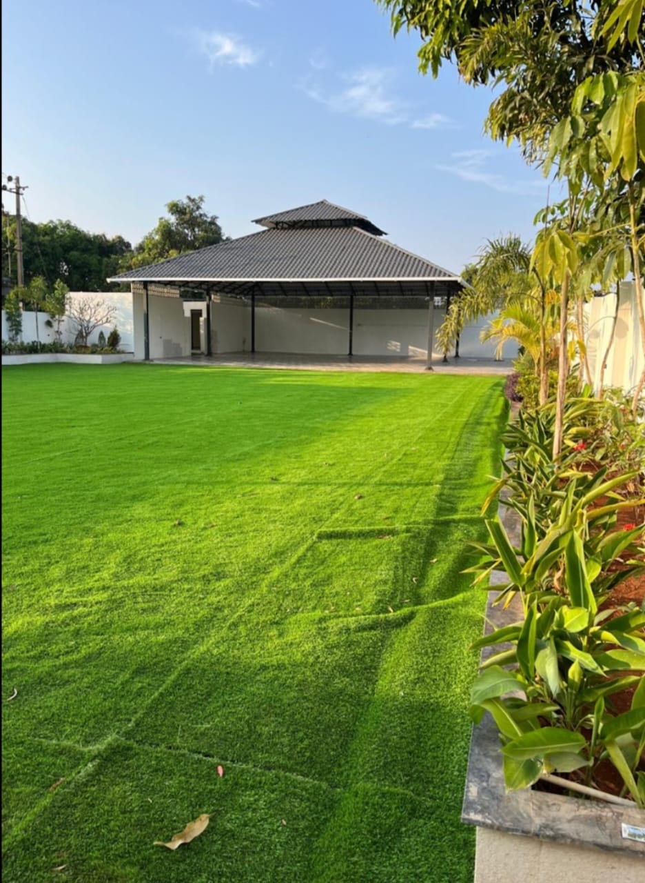 Open lawn and covered pavilion in daylight